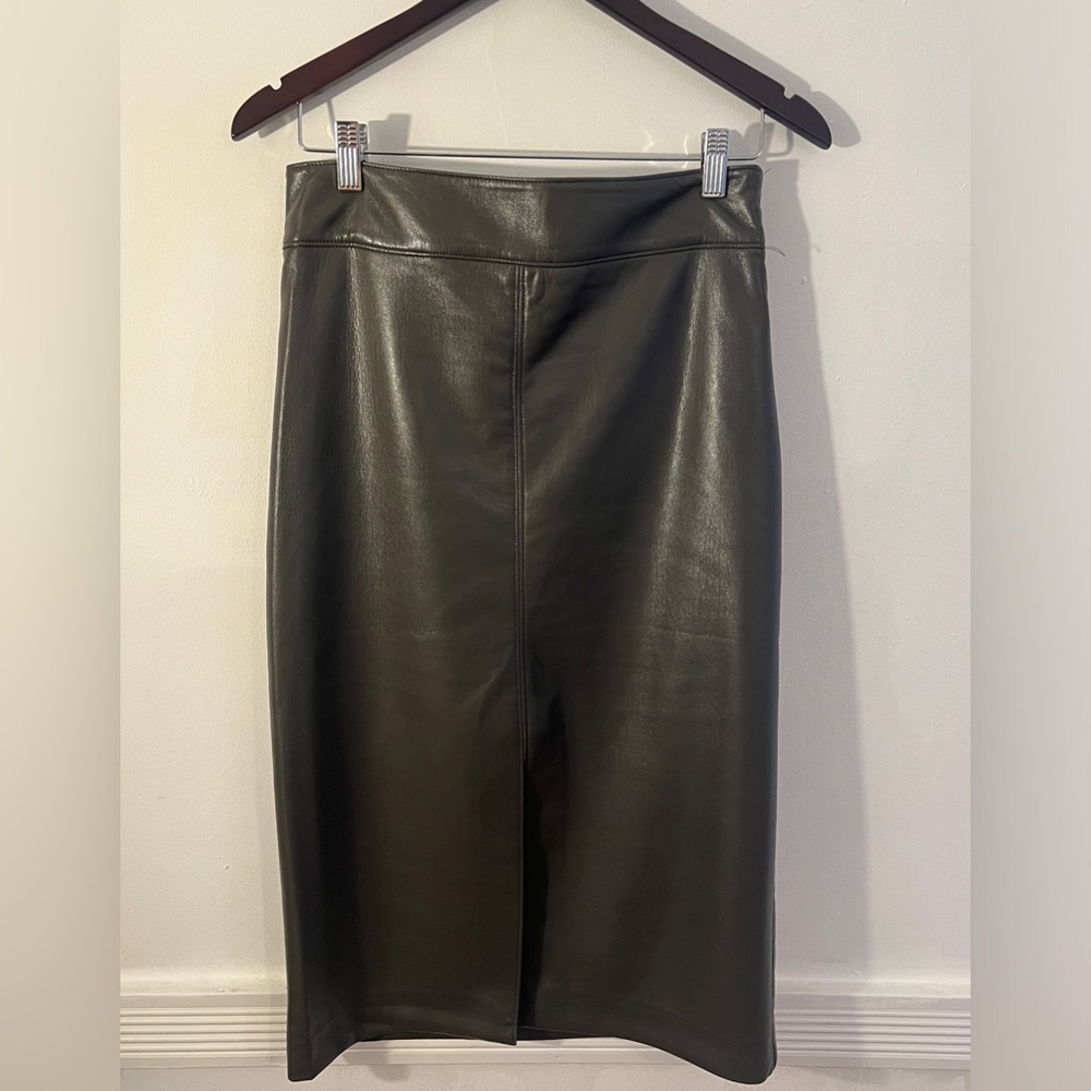 Elie Tahari mid length faux leather skirt in a dark green. Slit in front.